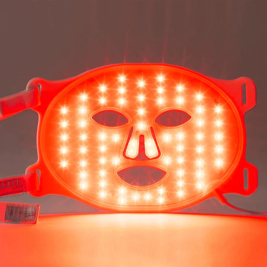 Red LED face mask on a dark background