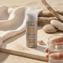Load image into Gallery viewer, SkinMedica sunscreen bottle on a natural setting with stones and glass
