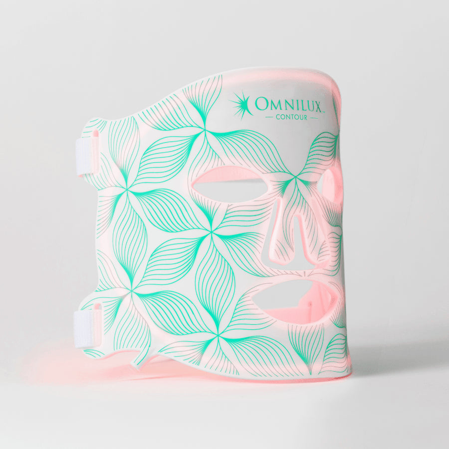 A red light therapy device with a floral pattern design in pink and white tones.